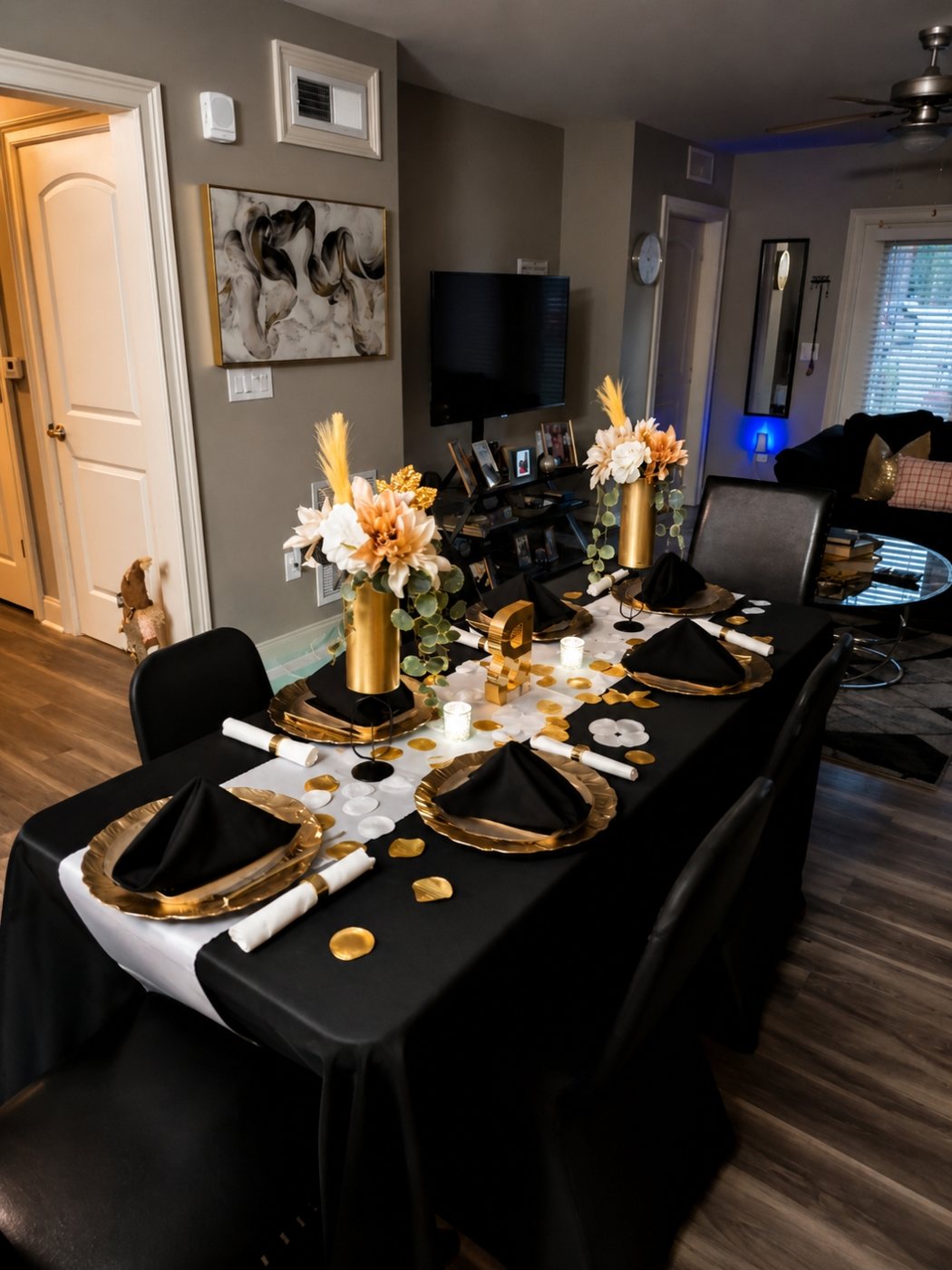 Black and gold tablescape with gold chargers